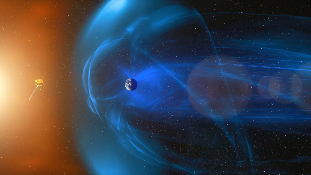 Ilustração do campo magnético da Terra, representado por linhas azuis que emanam do planeta e se curvam ao seu redor, formando uma proteção contra partículas solares. À esquerda, a luz do Sol emite radiação em direção à Terra, enquanto uma sonda espacial observa o fenômeno à distância.